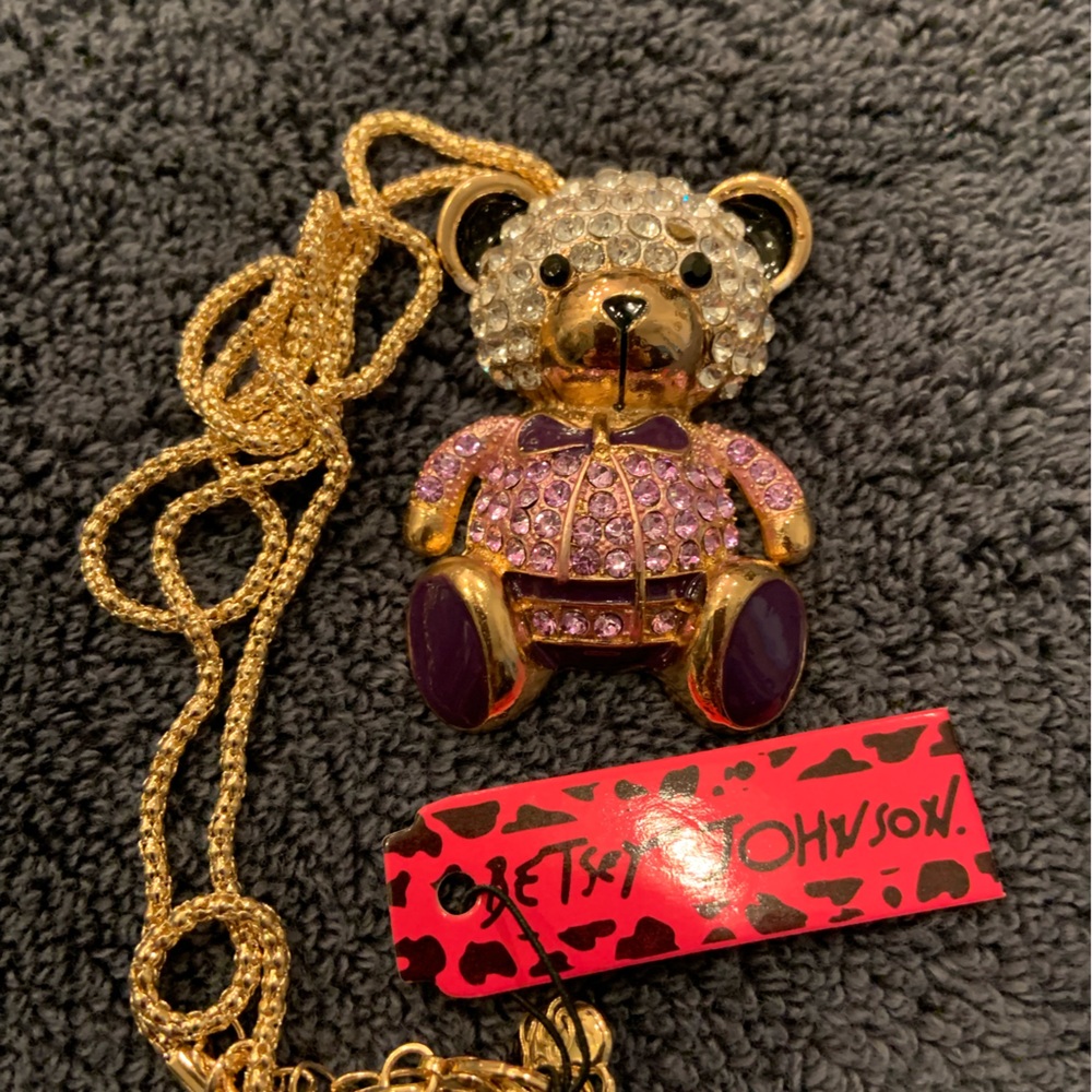 BJ boy teddy bear with lavender and purple rhinestones.  Drop is 12”.